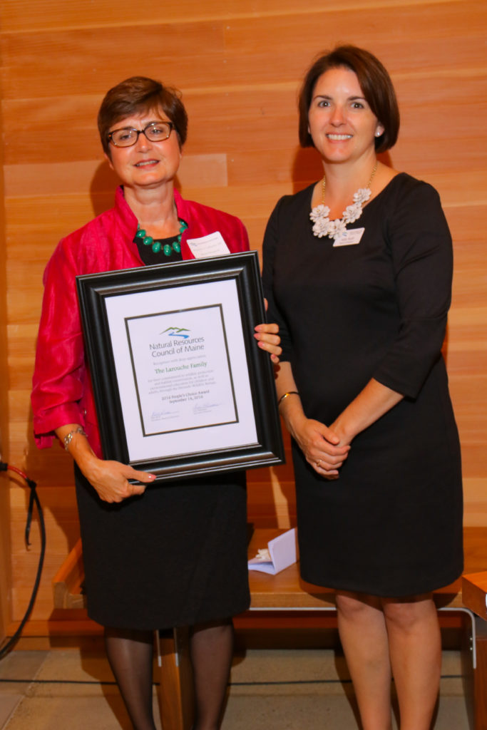 Dr. Stephanie Larouche, on behalf of the Larouche family, receives the 2016 NRCM People's Choice Award from NRCM Board President Kate Rush