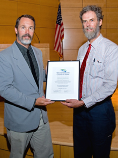 Zip Kellogg (right) accepts a 2011 Environmental Award for Lifetime Achievement awarded posthumously to his sister, Judy Kellogg Markowsky, a long-time naturalist and environmental educator.