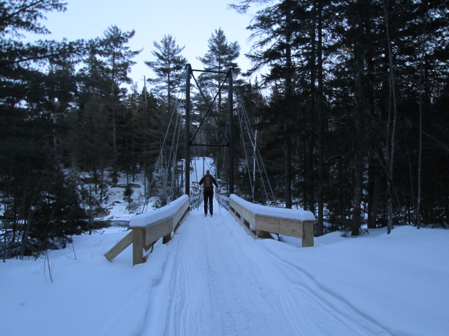 skier crossing footbridge