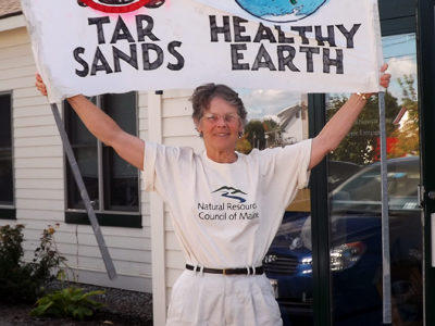 Cathy Johnson with climate sign