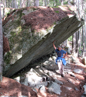 Lisa holding up boulder