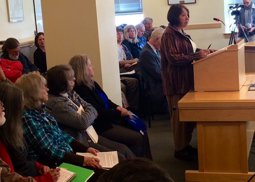 Rep. Janice Cooper speaking at the LD 146 public hearing. Seated at left, Alice Bolstridge, Gail Maynard, and Shelly Mountain, waiting to testify in opposition to the bill. They traveled to the Augusta hearing from Aroostook County.