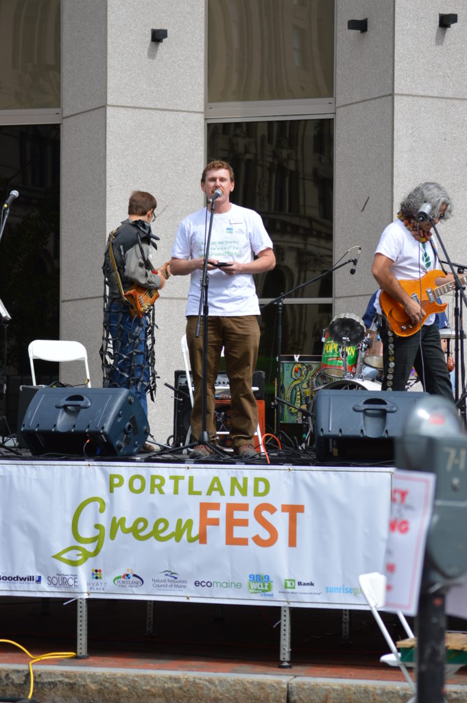 NRCM's Todd Martin reads some Maine Green Minutes on the stage at Greenfest