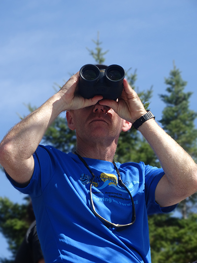 Pete using binoculars on Barnard Mountain hike