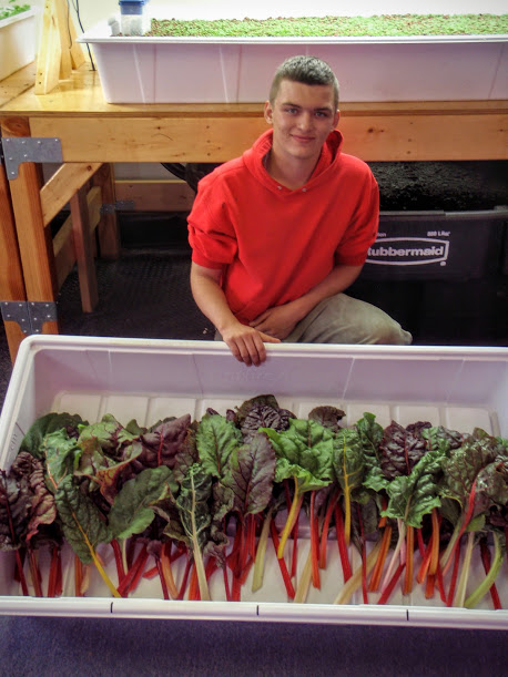 Student with some of the food they have grown with their Aquaponics system