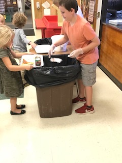 students sorting lunch trash at Sebago Elementary