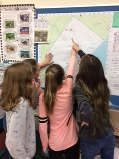 Students studying map at Loranger Memorial School