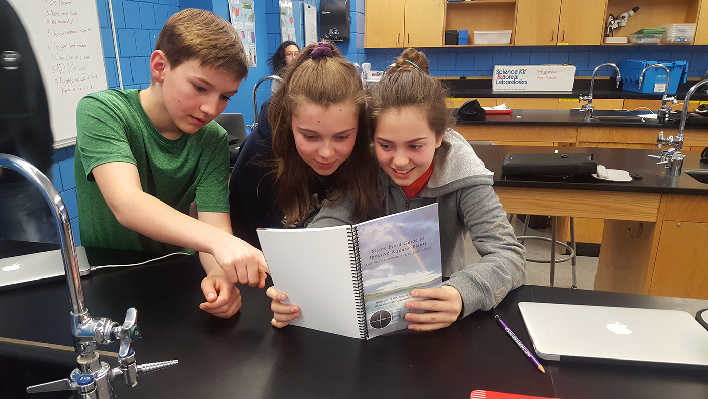 Hope Elementary School 7th Graders Aaron, Guine, and Sophie learning about invasive plants in Maine.