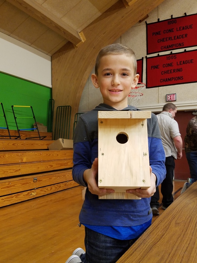 Finn shows off his completed chickadee house