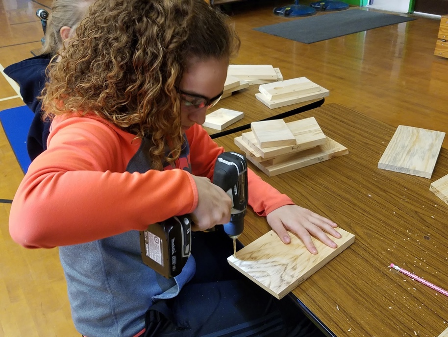 Natalie working on her birdhouse