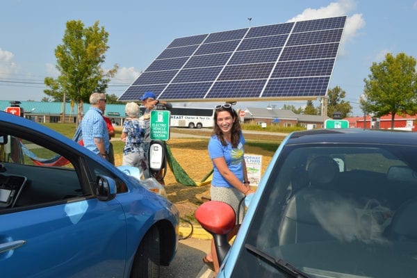 NRCM's Sophie Janeway charges a vehicle at a solar-powered electric vehicle charging station at Oxford Hills High School in South Paris, Maine