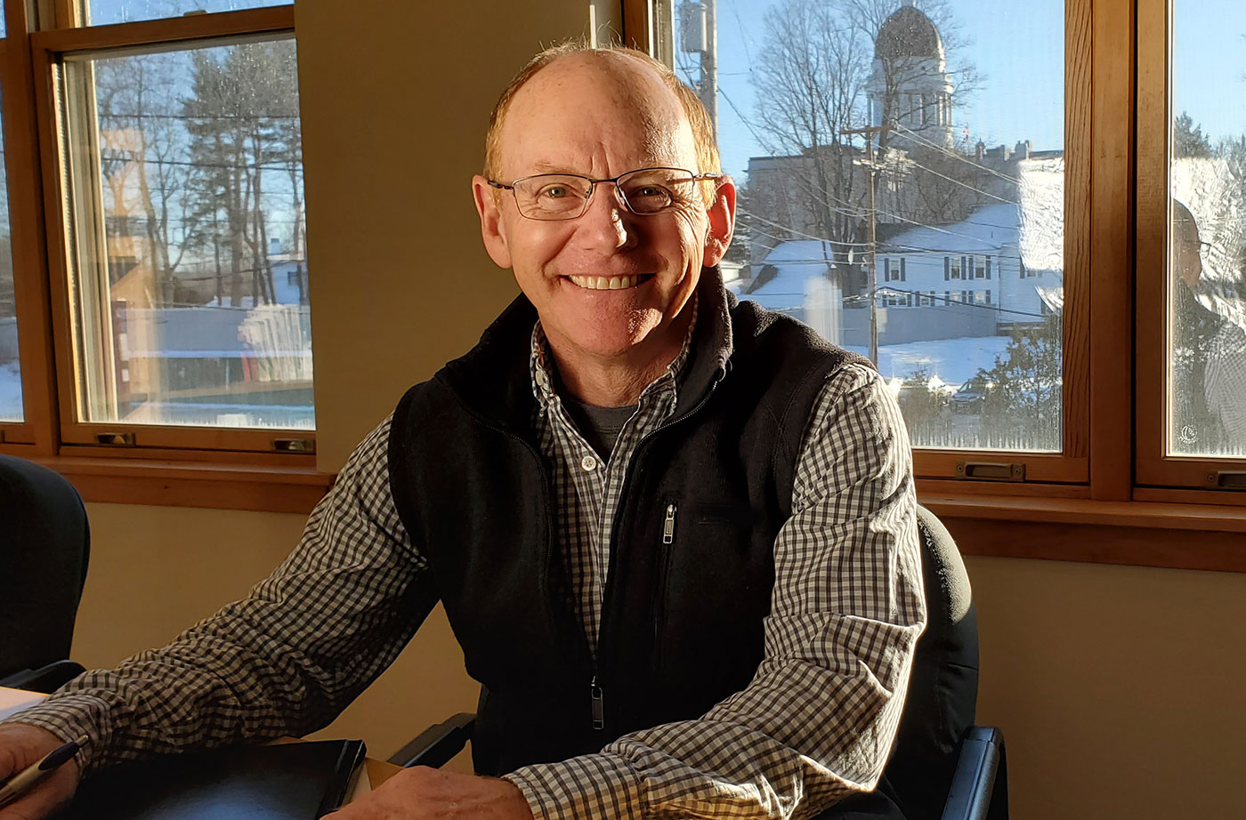 Pete Didisheim in NRCM library with State House in background