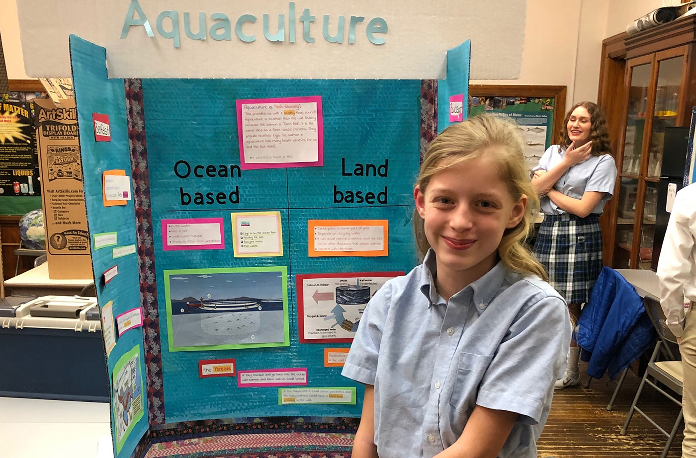 student with salmon aquaculture info