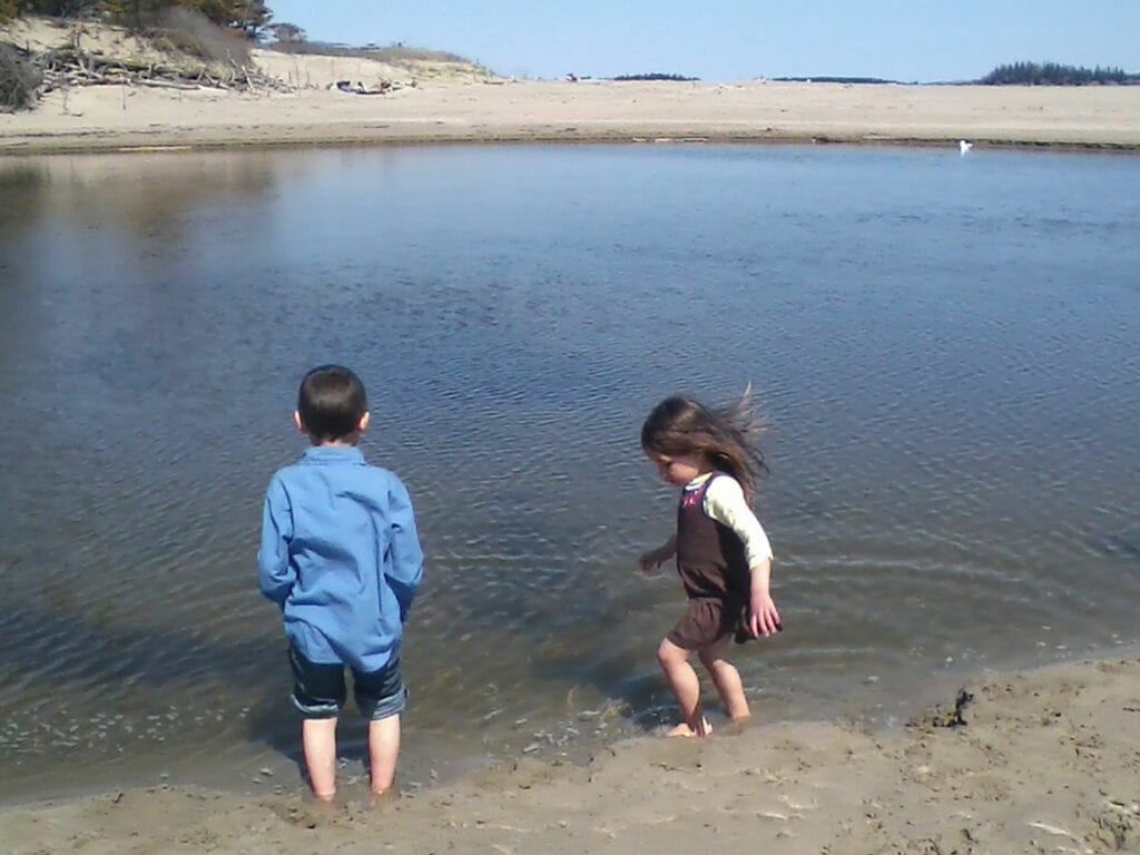 children playing in water on Maine coastline
