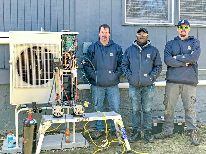 workers installing heat pump