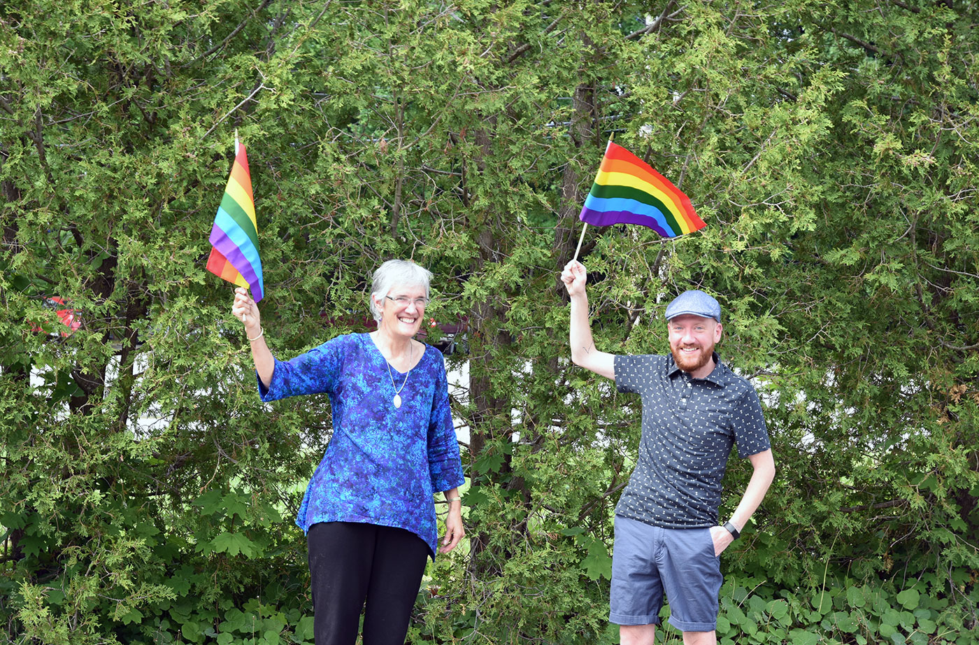 Lisa and Levi waving pride flags