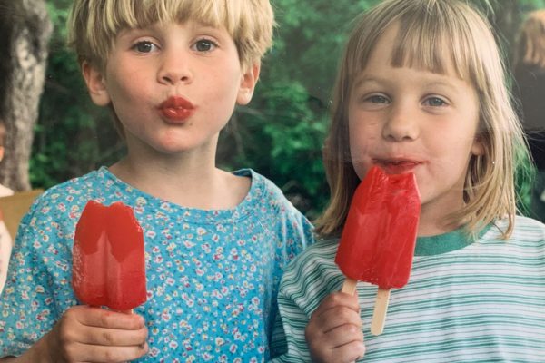 two girls eating popsicles