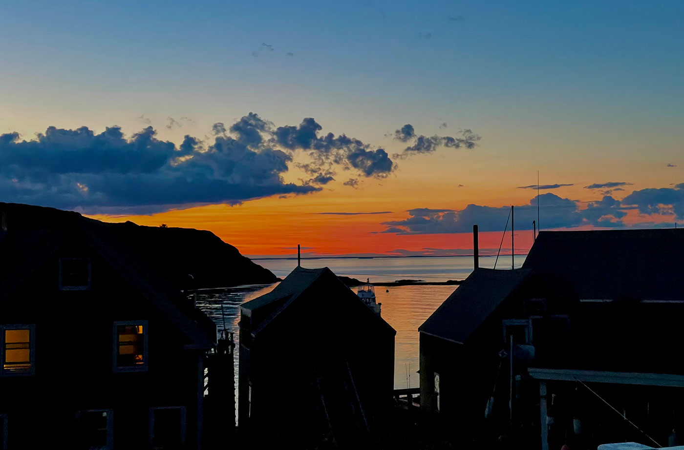 Sunrise over buildings at Maine coast