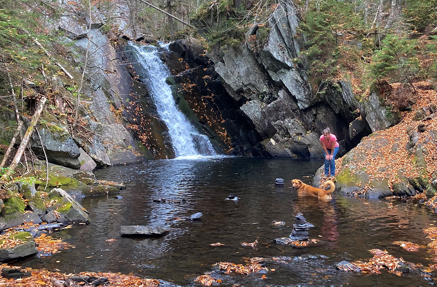 Cold Stream Falls waterfall with woman and dog in water