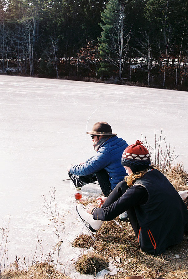 two people lacing up ice skates