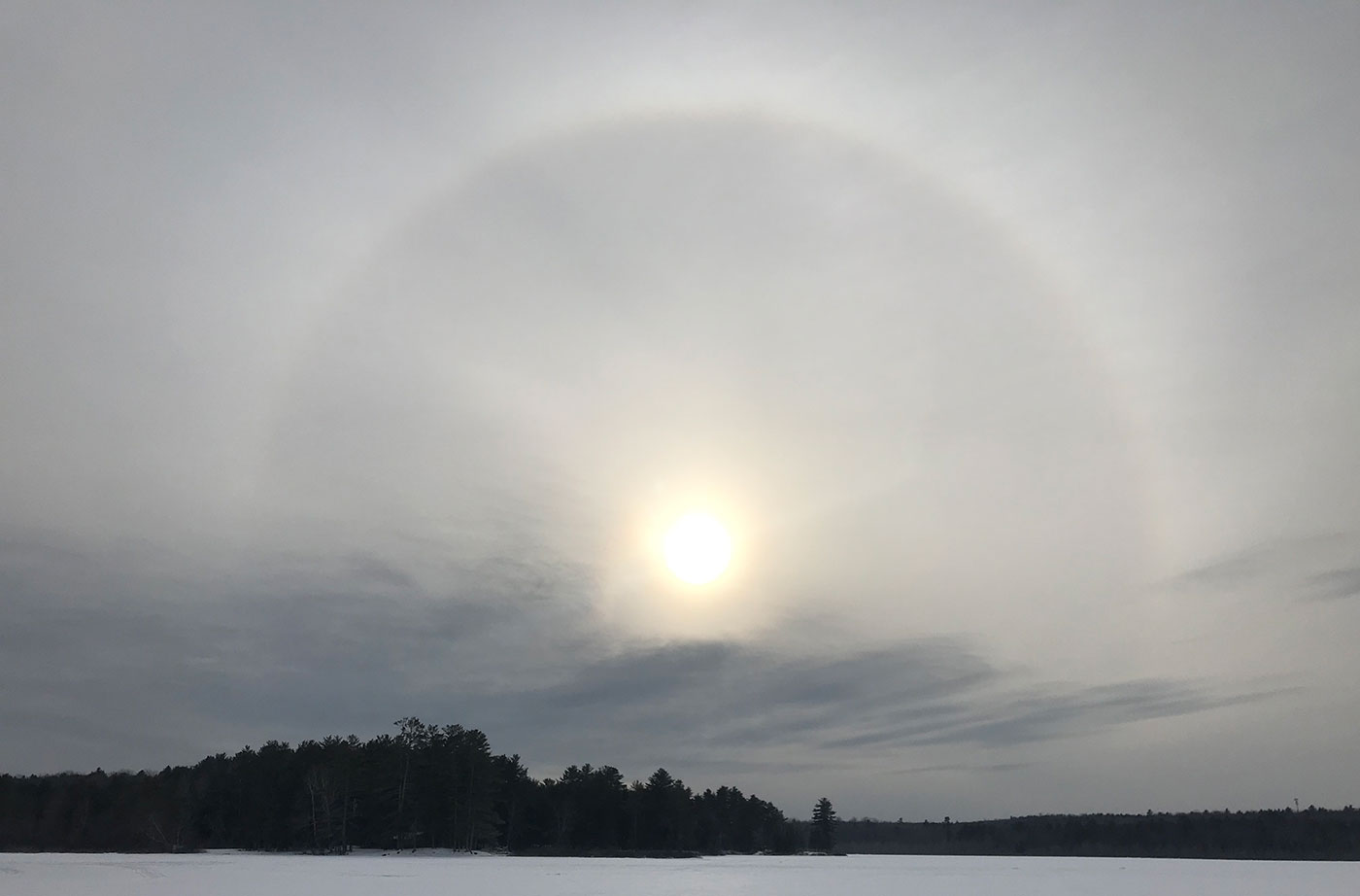 sun over ice-covered pond