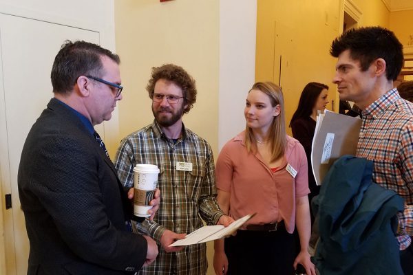 Mainers talking with legislator at State House