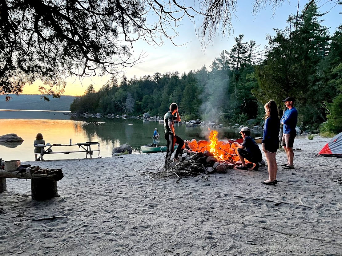 famly camping on lake shore