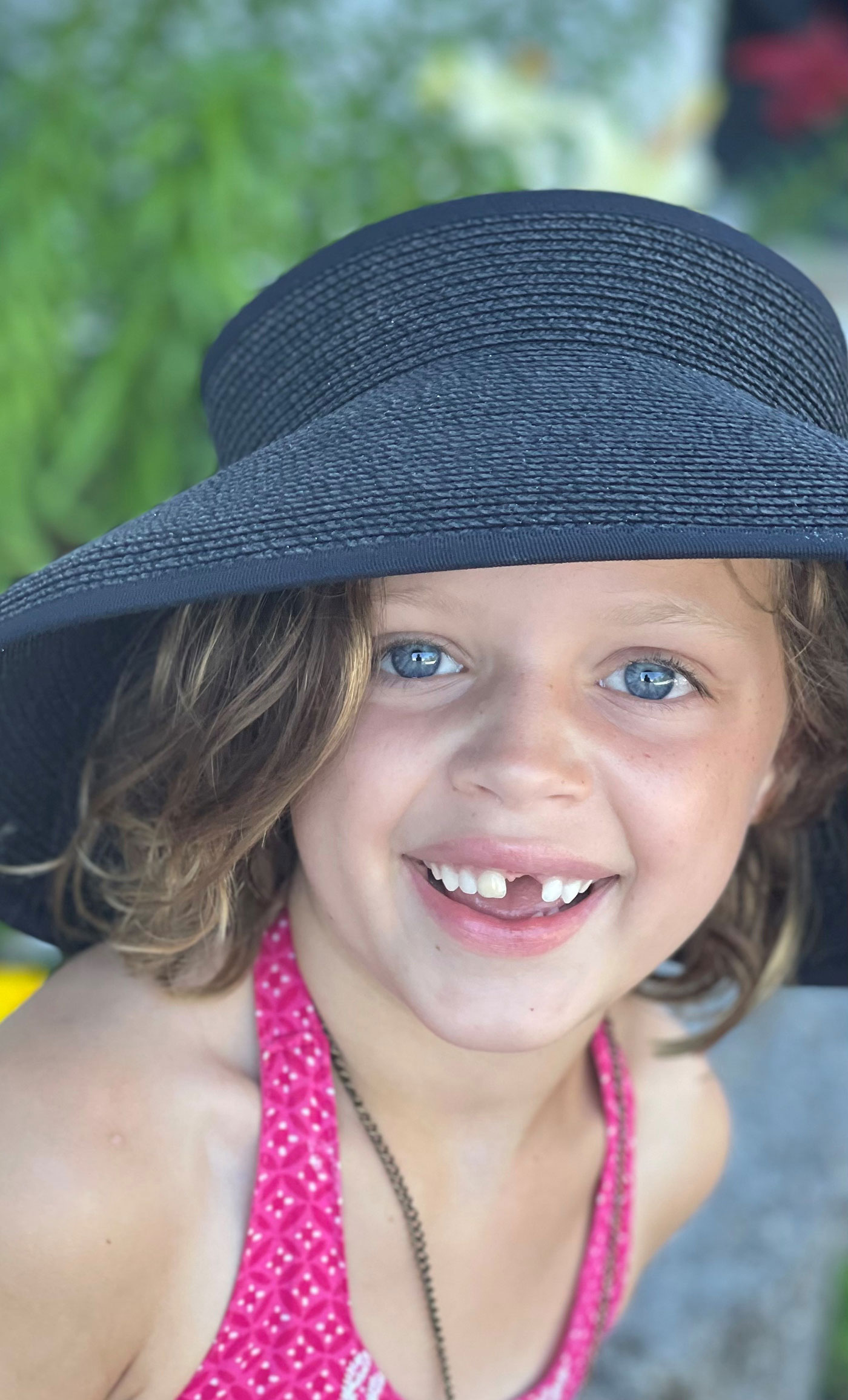 young girl in hat, smiling