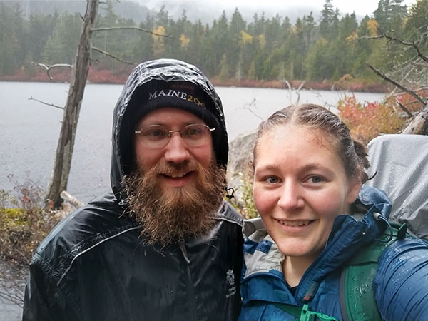 two people taking selfie, hiking in rain