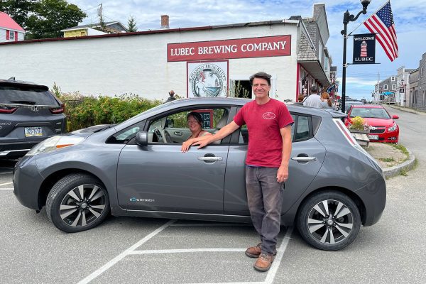 Lubec-Brewing-Company-owners-with-EV Lubec Brewing Company owners with their electric car