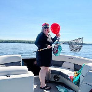 me with balloons and a fishing net on our boat