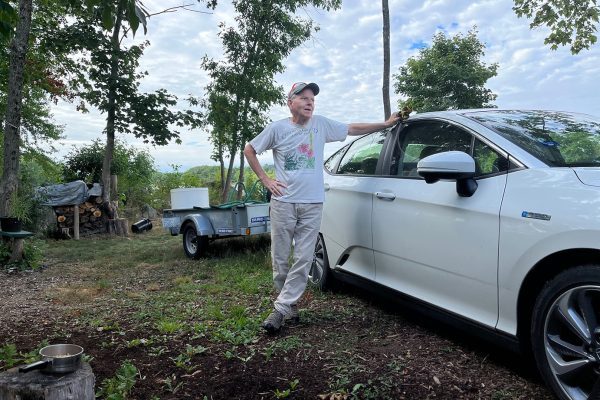 man with electric vehicle with trailer attached