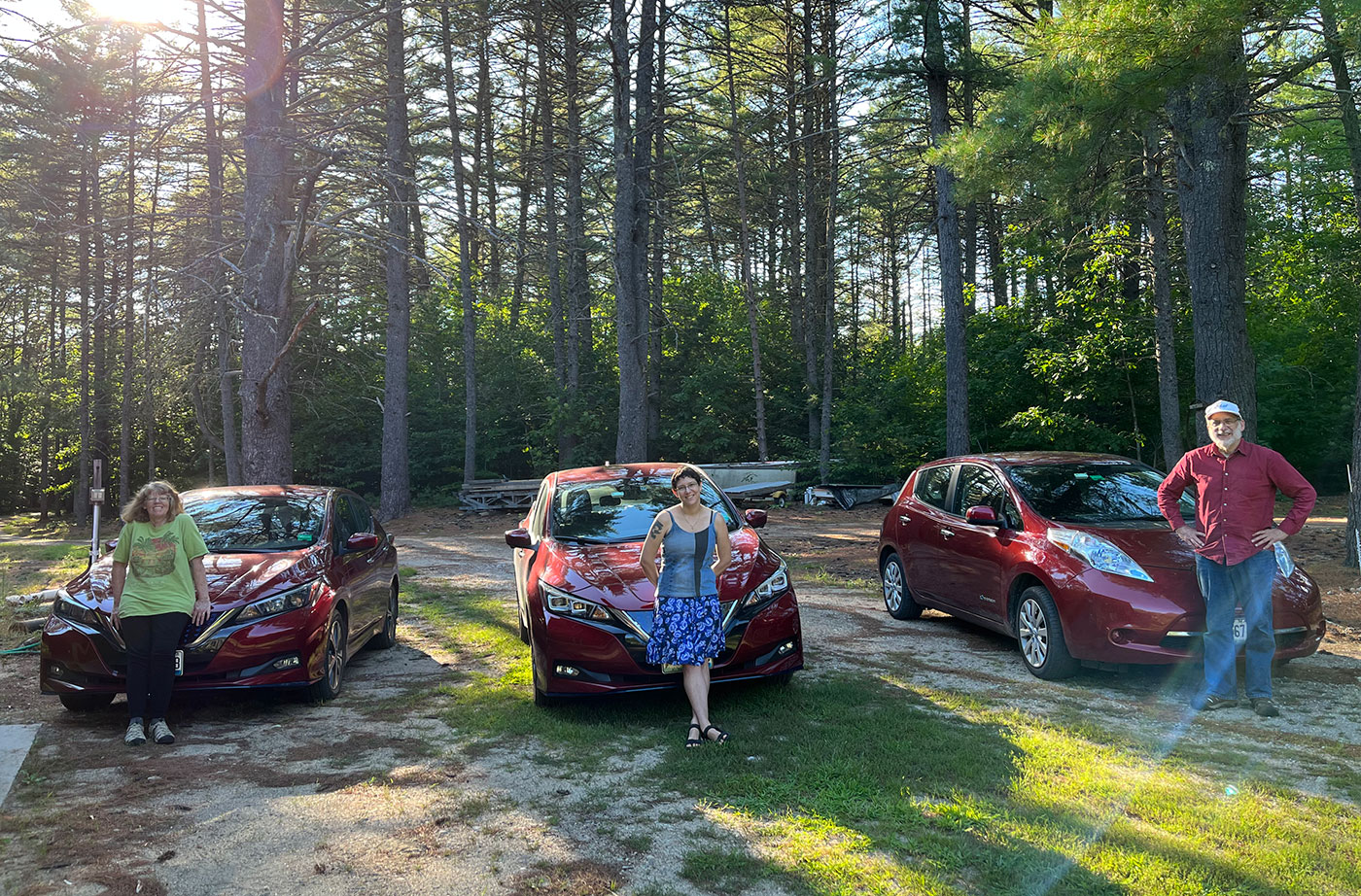 Three people with their electric vehicles