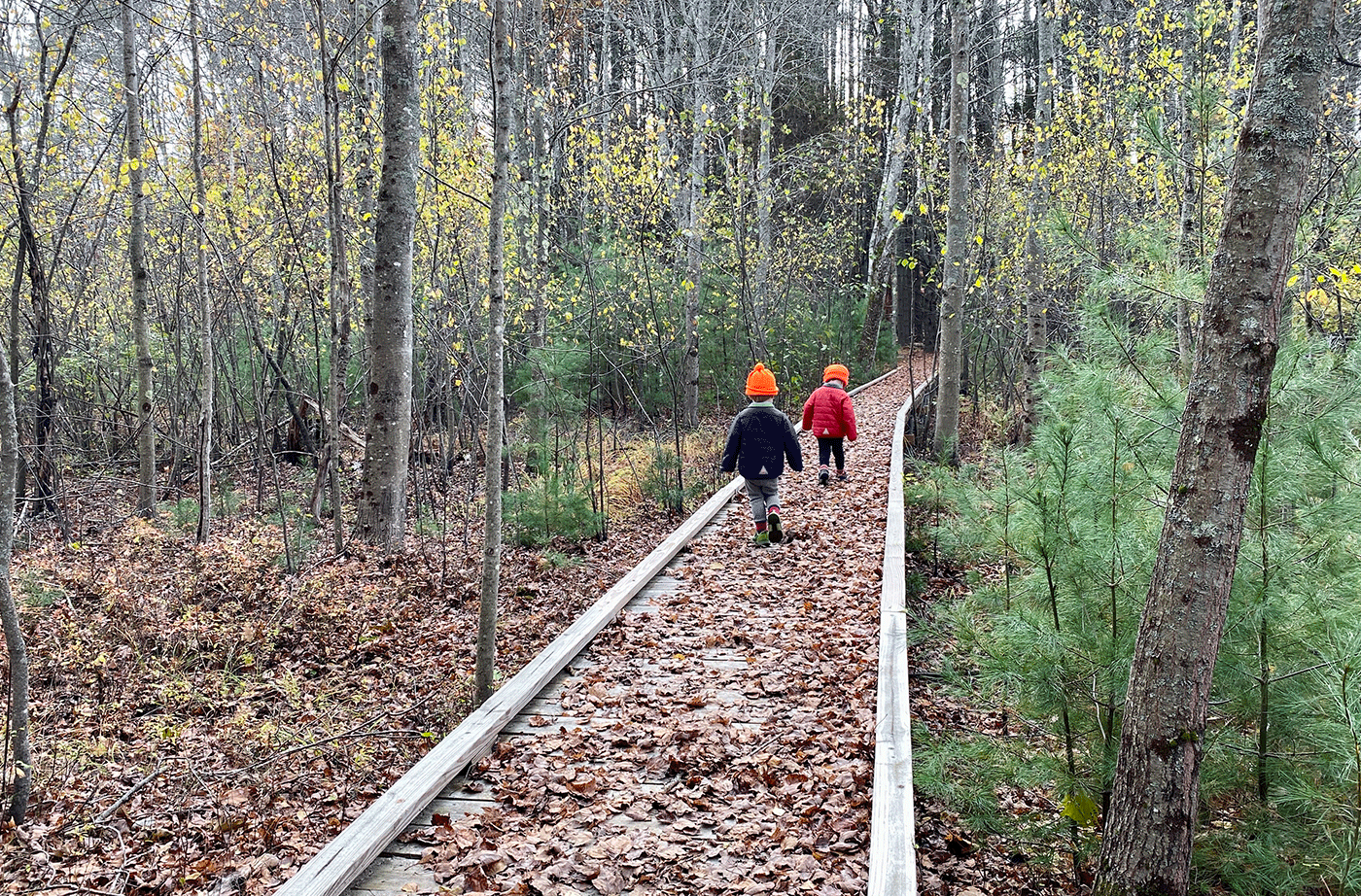 two young children hiking on path at Riverfront Preserve