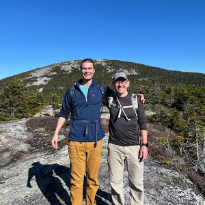 two men hiking on mountaintop