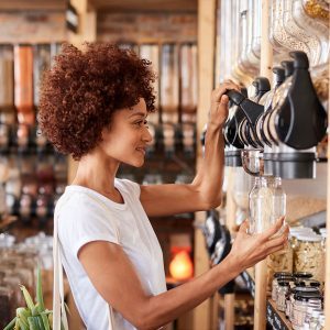 woman getting food from bulk bins