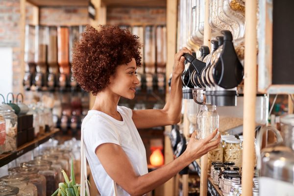 woman getting food from bulk bins