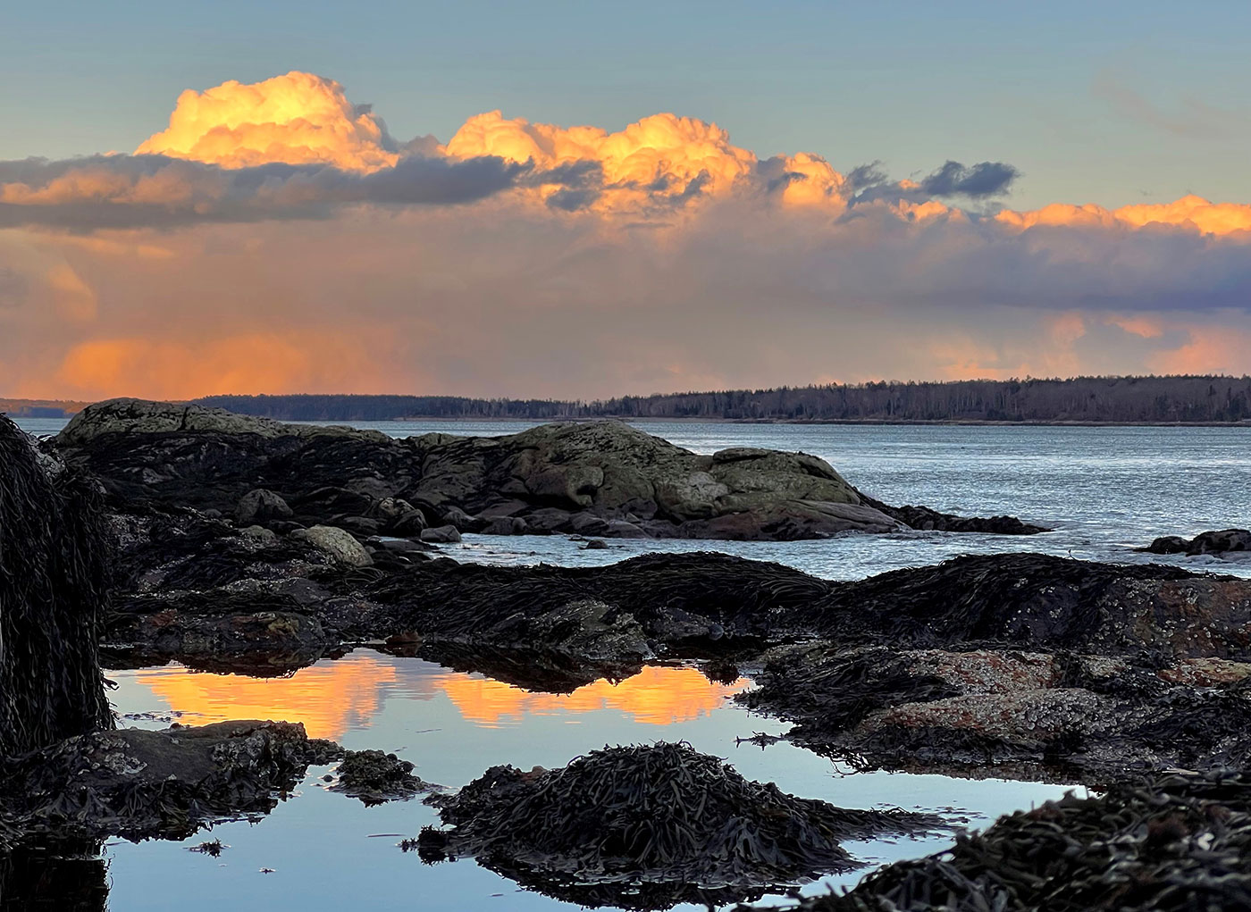 Snow squall and clouds over rocks in Muscongus Bay