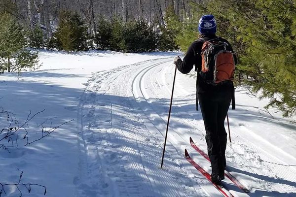 person skiing down trail