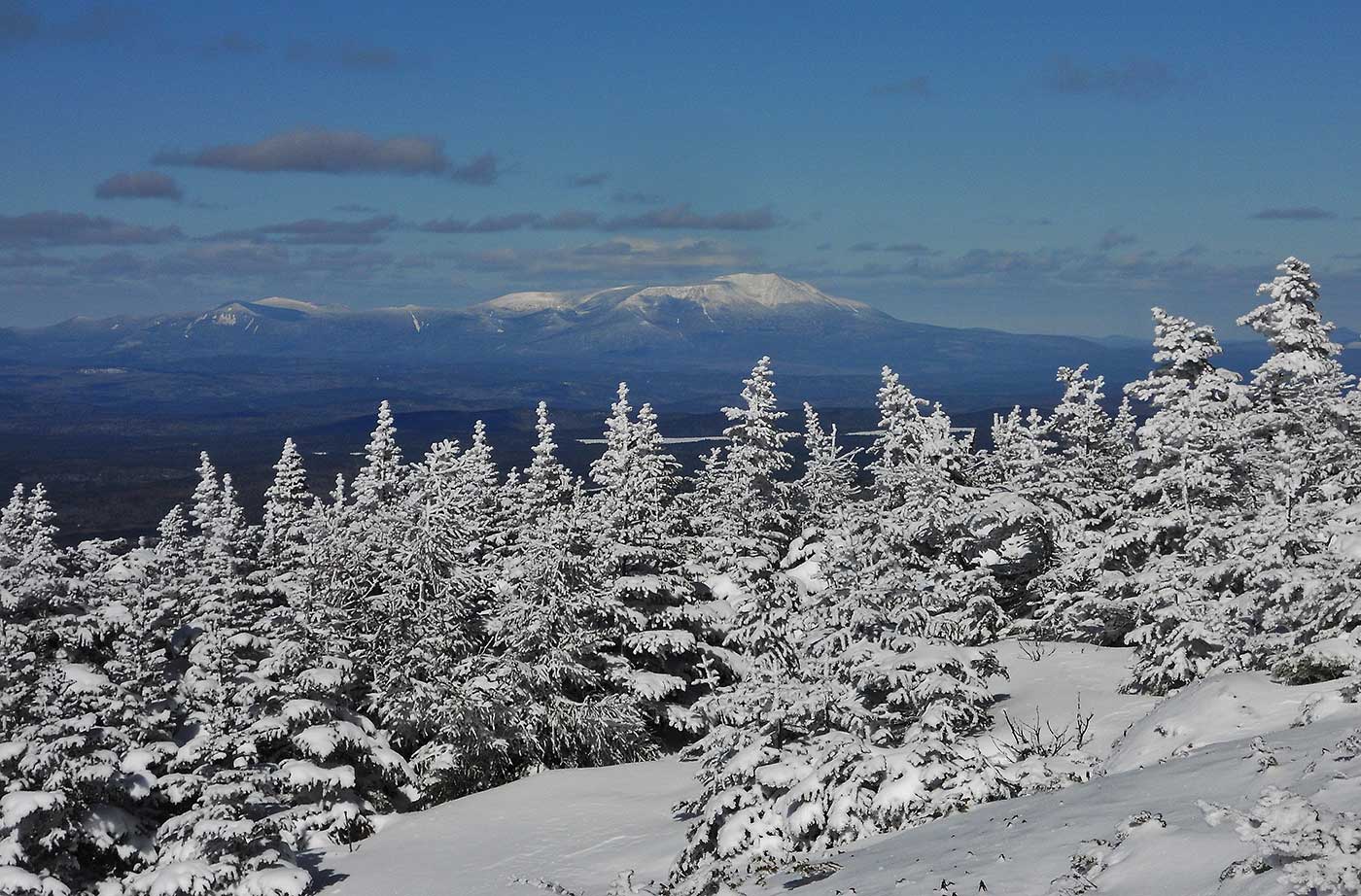 View of Katahdin from White Cap Mountain over snowy trees. Photo by Wendy Weiger