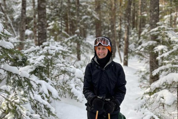 Ari O'Neill skiing in woods