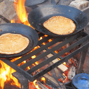 pancakes cooking over open fire