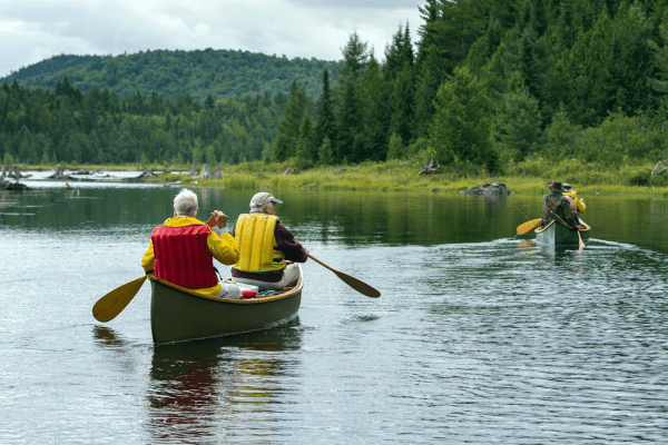 two people back-to paddling down river