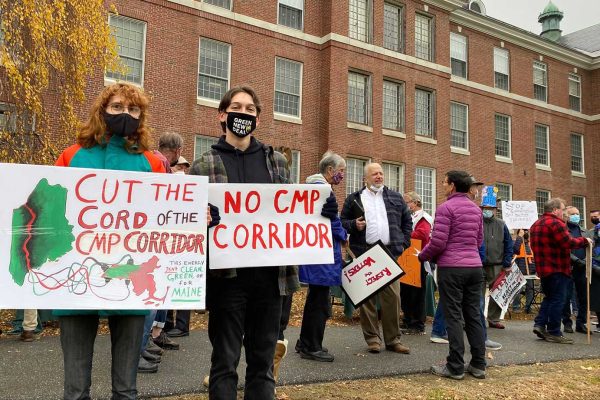 People with signs protesting CMP corridor