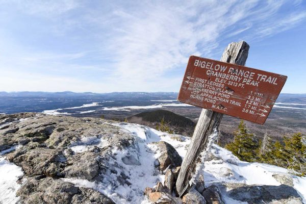 Bigelow Cranberry Peak sign atop snow-covered mountain