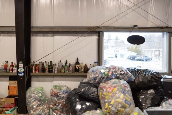 Image of bags of cans with bottles in the background.