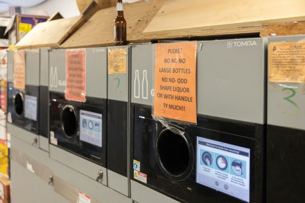 Automatic sorting machine with signs at Portland Redemption Center.