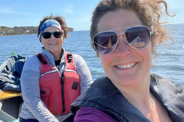 Two women smiling in a rowboat