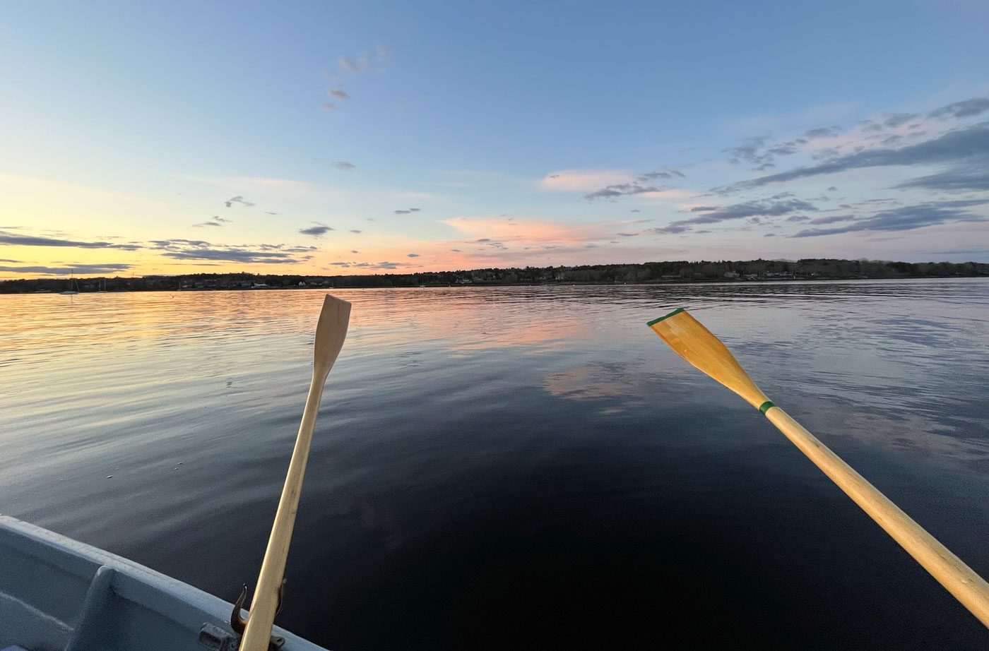 Two orrs against the sunset on the open bay