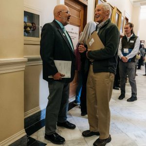 Sen-Russell-Black-Tony-Owens-talking-SHAD-2023-AlyssaPereira Two men speaking in State House hallway